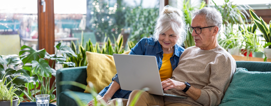 Life Assure Senior Woman Sitting In Chair And Laughing With Caregiver Nurse Hero